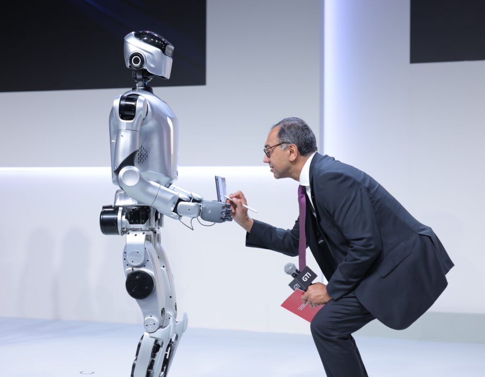 Image GSMA de Vivek Badrinath avec un robot au MWC 2026. 